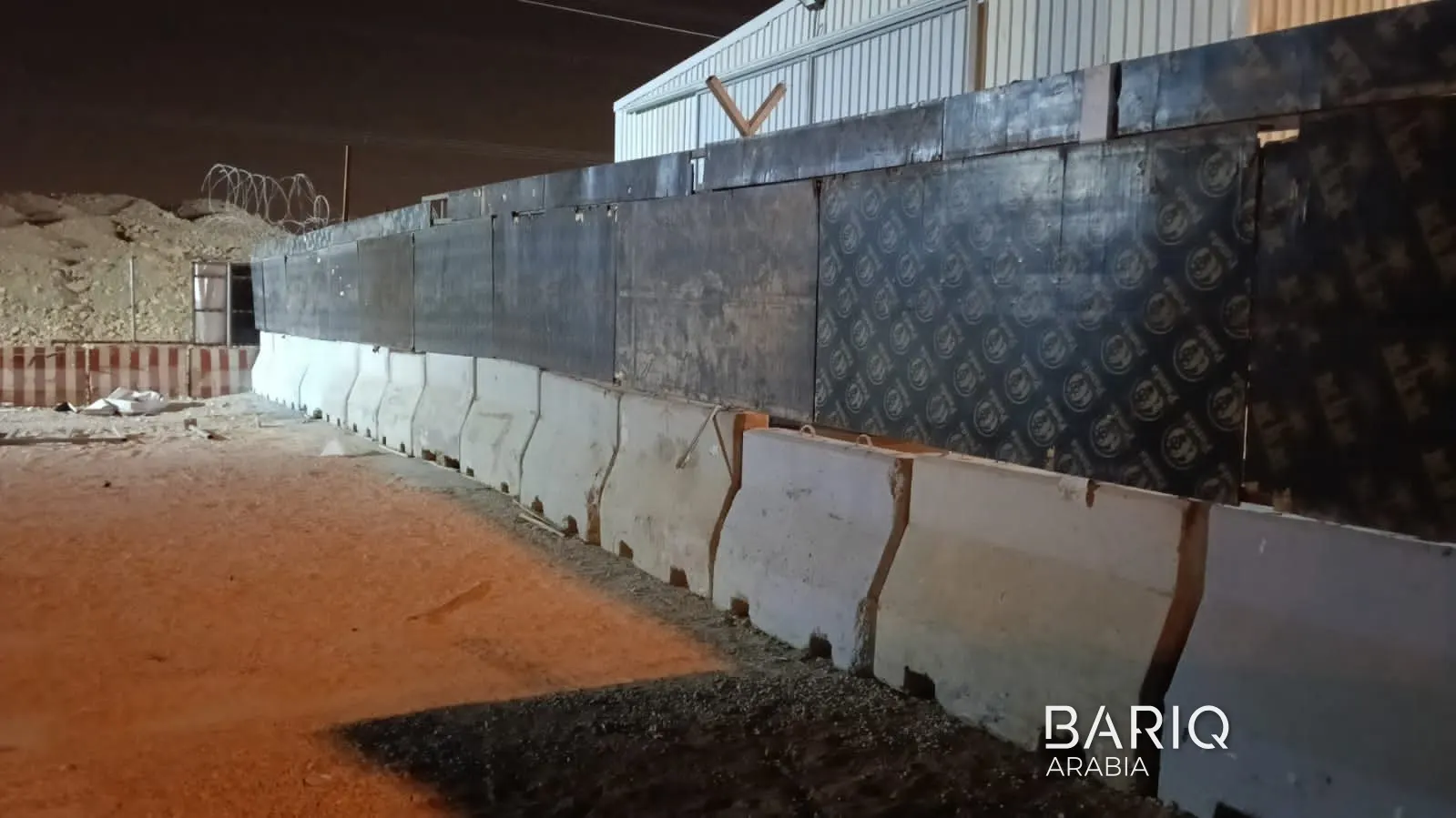 Line of concrete barriers in front of Sports Boulevard hoarding in Riyadh