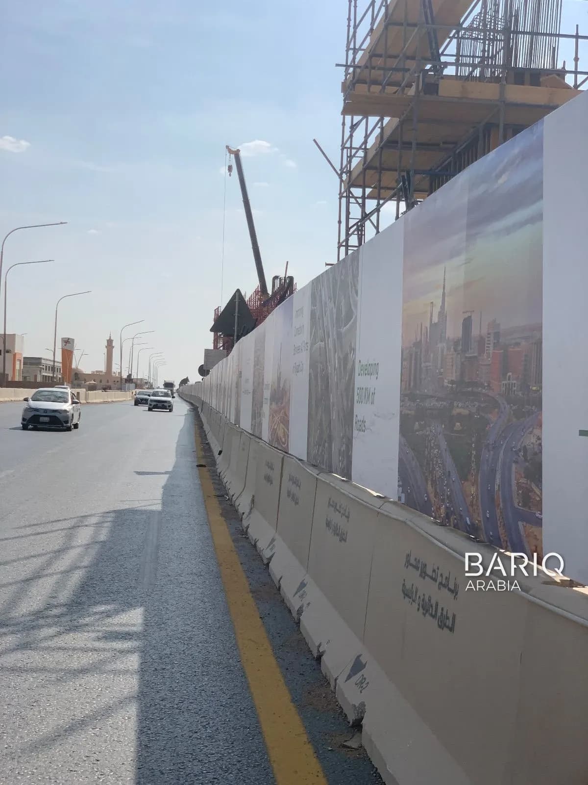 New Jersey barriers carrying site hoarding beside traffic on Dirab Road