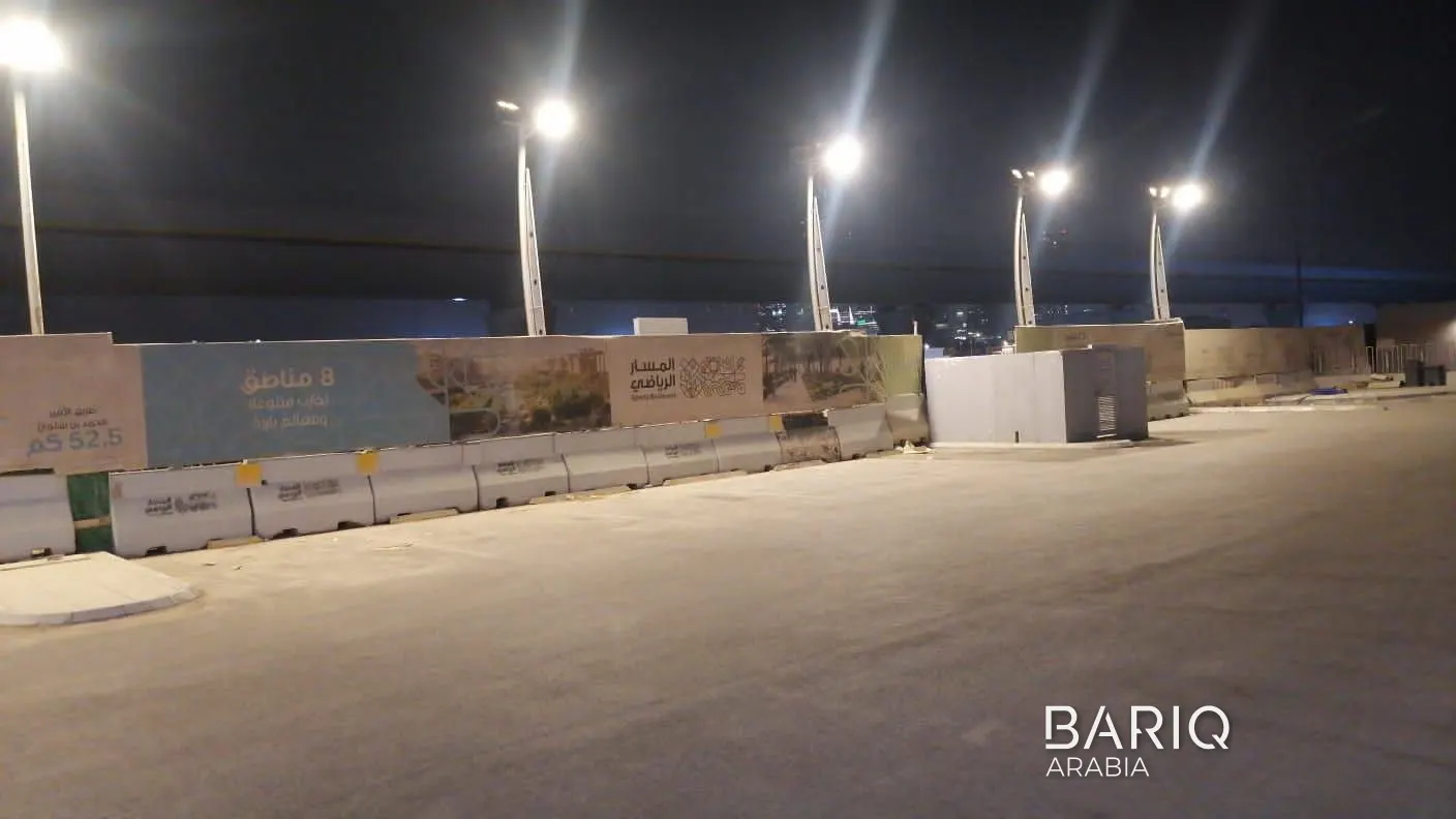 Sports Boulevard hoarding along the edge of the work site behind concrete barriers