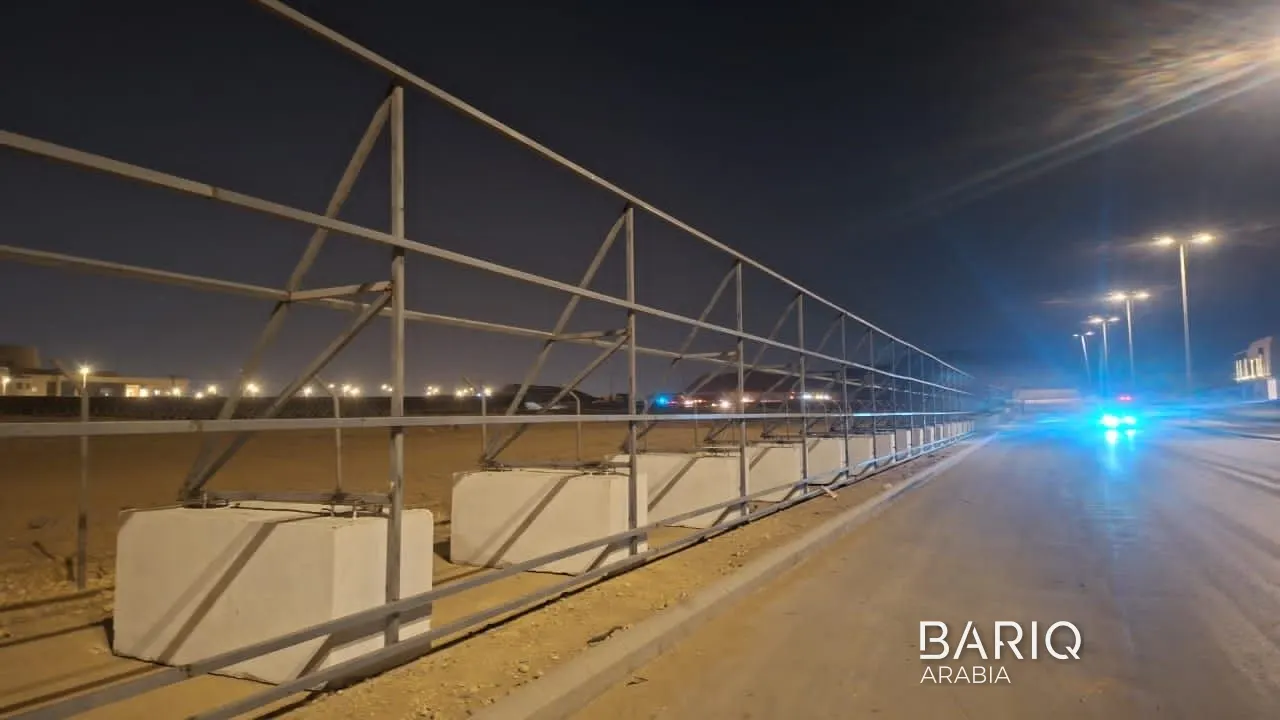 Steel hoarding frames with triangular braces in Al Janadriyah at night