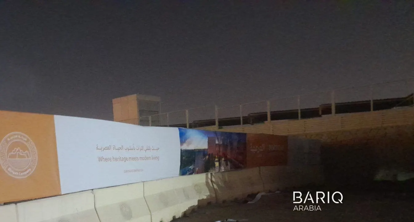 Printed hoarding on a concrete barrier base in Diriyah